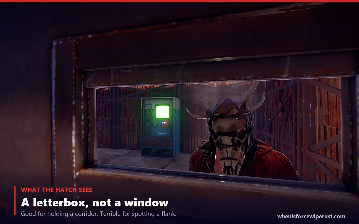 Looking through the open hatch of a Rust armored door at a base interior with a vending machine