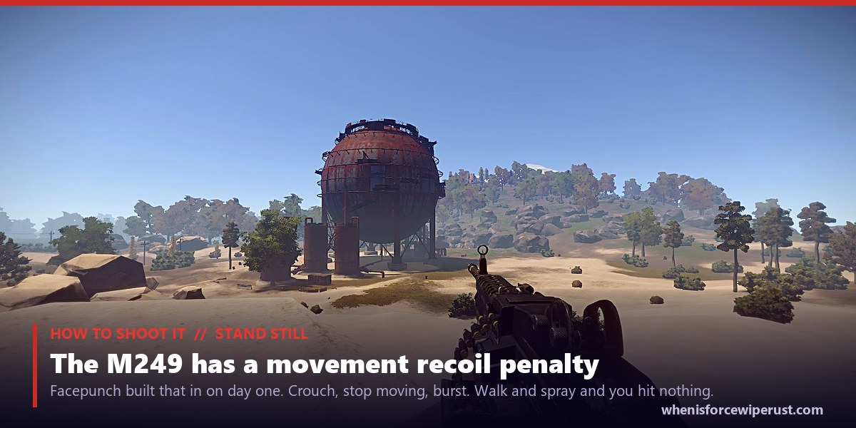 First person view of the M249 in Rust with the 5.56 ammo belt feeding into the receiver, aimed across the desert at the Dome monument, an actual in-game screenshot showing the belt fed light machine gun view model