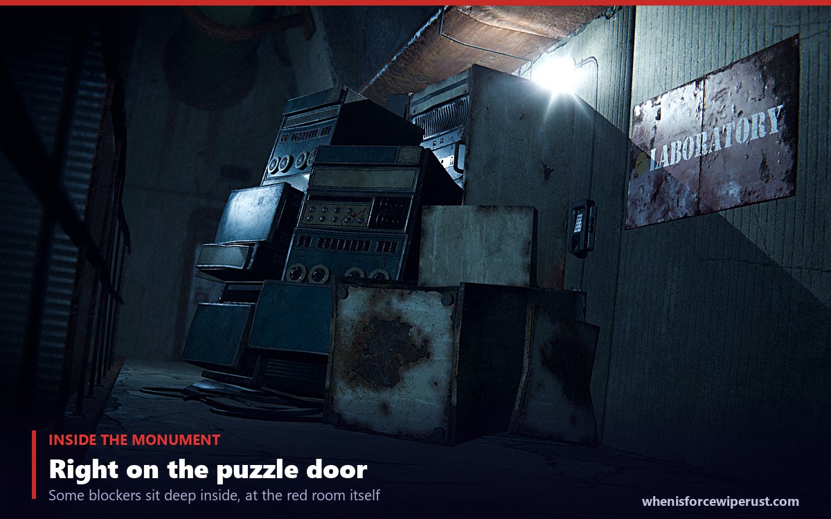 A Rust monument blocker sealing a laboratory doorway deep inside a red keycard monument